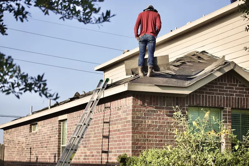 Professional roofer working on a residential roof in La Crescent
